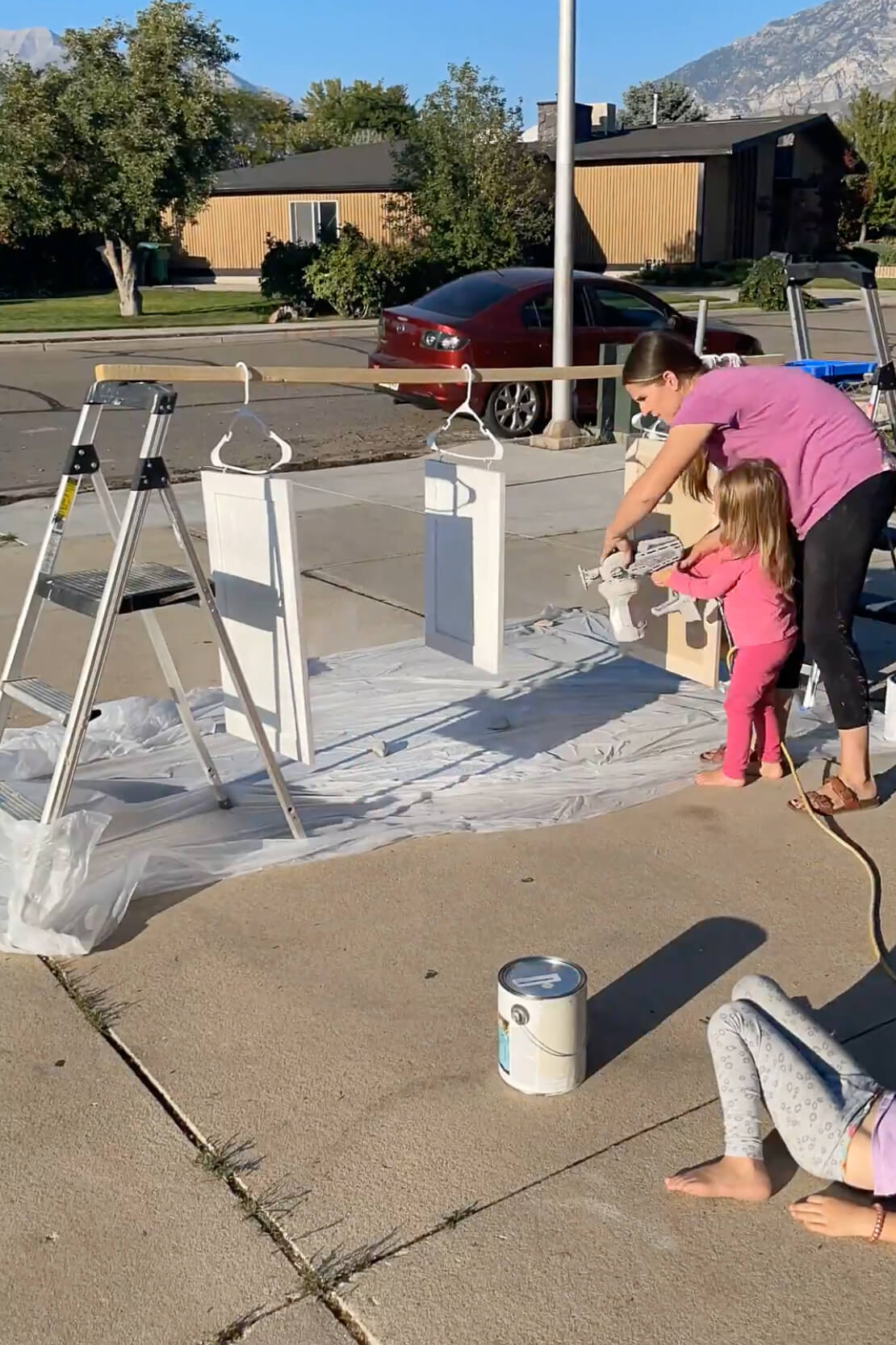 Hanging kitchen cabinet doors to paint with a sprayer.